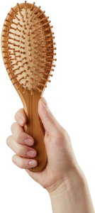 Picture of a hand holding a hair brush with white text overlay that says 'your next steps'.
