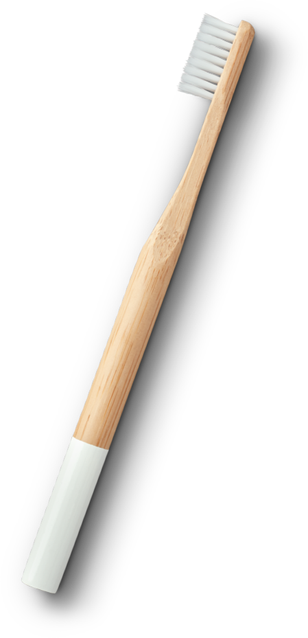 Wood toothbrush with white handle and white bristles.